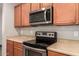 The kitchen has stainless steel appliances, wood cabinets, and light-colored countertops at 18008 W Tina Ln, Surprise, AZ 85387