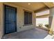 View of covered patio with decorative tile accents and a screened door leading to the backyard at 18008 W Tina Ln, Surprise, AZ 85387
