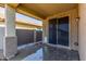 A covered patio with concrete floor, a ceiling fan, and sliding door with backyard view at 18008 W Tina Ln, Surprise, AZ 85387