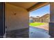 The covered patio features a concrete floor and overlooks the grassy backyard with a shed at 18008 W Tina Ln, Surprise, AZ 85387