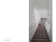 Descending carpeted staircase with white railing, offering a view toward the home's entrance at 1961 N Hartford St # 1109, Chandler, AZ 85225