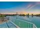 Scenic backyard view overlooking a tranquil lake with a water fountain feature at sunset at 2094 N Sweetwater Dr, Casa Grande, AZ 85122