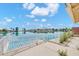 Expansive backyard view featuring a serene lake, a metal fence, and mature landscaping at 2094 N Sweetwater Dr, Casa Grande, AZ 85122