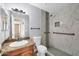 Bright bathroom with tiled shower, mosaic accents, safety bars, and granite sink at 2094 N Sweetwater Dr, Casa Grande, AZ 85122
