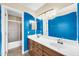 Bright bathroom features a double sink vanity, large mirror, and a shower with a glass door at 2094 N Sweetwater Dr, Casa Grande, AZ 85122