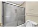 Bathroom area featuring a sliding shower door and toilet in neutral color palette at 2094 N Sweetwater Dr, Casa Grande, AZ 85122