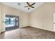 Bedroom featuring tile floors, a ceiling fan, and sliding door access to a patio with a pool view at 2094 N Sweetwater Dr, Casa Grande, AZ 85122
