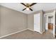 This cozy bedroom features neutral walls, tile flooring, and a ceiling fan at 2094 N Sweetwater Dr, Casa Grande, AZ 85122
