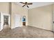 Bedroom featuring tile floors, a ceiling fan, and access to a bathroom at 2094 N Sweetwater Dr, Casa Grande, AZ 85122