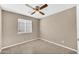 Bedroom featuring neutral walls, tile floors, a window, and a ceiling fan at 2094 N Sweetwater Dr, Casa Grande, AZ 85122
