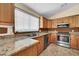 Traditional kitchen featuring stainless steel appliances and wood cabinetry at 2094 N Sweetwater Dr, Casa Grande, AZ 85122