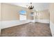 Bright living room with wainscotting, decorative chandelier, large arched windows, and tile flooring at 2094 N Sweetwater Dr, Casa Grande, AZ 85122