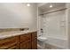 Bathroom has a granite countertop, wood cabinets, shower/tub combo, and toilet at 2111 N Piper Pl, Mesa, AZ 85215