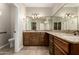 Bathroom features a granite countertop, wood cabinets, a large mirror, and tile flooring at 2111 N Piper Pl, Mesa, AZ 85215