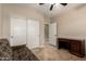 Bedroom with a ceiling fan, tile flooring, closet, and desk at 2111 N Piper Pl, Mesa, AZ 85215