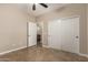 This bedroom has tile flooring, a ceiling fan, and a closet with sliding doors at 2111 N Piper Pl, Mesa, AZ 85215