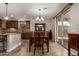 Dining area showcasing a wooden table set and access to the backyard patio at 2111 N Piper Pl, Mesa, AZ 85215