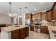 Charming kitchen featuring granite countertops, wooden cabinetry, and stainless appliances at 2111 N Piper Pl, Mesa, AZ 85215