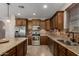 Well-equipped kitchen featuring stainless steel appliances and custom wood cabinetry at 2111 N Piper Pl, Mesa, AZ 85215