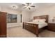 Comfortable main bedroom showcasing a decorative headboard and natural light at 2111 N Piper Pl, Mesa, AZ 85215