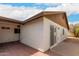 Exterior view of home's backyard, featuring a covered patio area and blue skies at 2524 W Kiva Ave, Mesa, AZ 85202