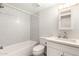 Clean bathroom with a shower-tub combo, white vanity, and updated fixtures at 2524 W Kiva Ave, Mesa, AZ 85202