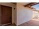 Covered porch area features a brown front door and neutral colored brick at 2524 W Kiva Ave, Mesa, AZ 85202