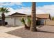 Exterior view of a one story home featuring desert landscaping and a two-car garage at 2524 W Kiva Ave, Mesa, AZ 85202