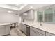 Bright kitchen boasts stainless steel appliances, wood-look flooring, and light-colored cabinets and countertops at 2524 W Kiva Ave, Mesa, AZ 85202