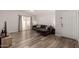 Spacious living room features updated wood look flooring and a sliding glass door at 2524 W Kiva Ave, Mesa, AZ 85202