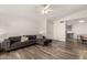 Spacious living room features updated wood look flooring and a ceiling fan at 2524 W Kiva Ave, Mesa, AZ 85202