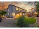 Beautifully landscaped backyard with lush lawn and a view of the two-story home at dusk at 2754 E Michelle Way, Gilbert, AZ 85234