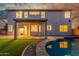 Spacious backyard featuring a pool, covered patio, and large windows with natural light at dusk at 2754 E Michelle Way, Gilbert, AZ 85234