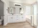 This bathroom showcases a double sink vanity and a shower and tub combo at 2754 E Michelle Way, Gilbert, AZ 85234