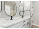 Bathroom featuring dual sinks, two mirrors, and white cabinets at 2754 E Michelle Way, Gilbert, AZ 85234
