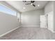 This bedroom features neutral paint, a ceiling fan, two windows and plush carpeting at 2754 E Michelle Way, Gilbert, AZ 85234