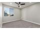 This bedroom features neutral walls, a ceiling fan, and a window with a view at 2754 E Michelle Way, Gilbert, AZ 85234