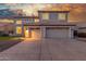 Stunning two-story home featuring a three-car garage and tile roof at sunset at 2754 E Michelle Way, Gilbert, AZ 85234