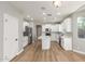 This bright kitchen features white cabinets, an island with a sink, and stainless steel appliances at 2754 E Michelle Way, Gilbert, AZ 85234