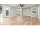 Sun-filled living room featuring light hardwood floors, ceiling fan, and backyard view at 2754 E Michelle Way, Gilbert, AZ 85234