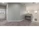 Loft area featuring a built-in desk, carpet flooring, and ample natural light from large windows at 2754 E Michelle Way, Gilbert, AZ 85234