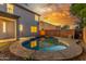 Backyard pool with stone surround and patio at dusk, offering a peaceful outdoor retreat at 2754 E Michelle Way, Gilbert, AZ 85234