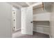 This walk-in closet has wood shelving and a white door at 2754 E Michelle Way, Gilbert, AZ 85234