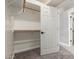 This walk-in closet features wood shelving and a white door at 2754 E Michelle Way, Gilbert, AZ 85234