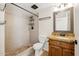 Clean and bright bathroom boasts a shower, vanity with granite counters, and a stylish mirror at 3228 W Mercer Ln, Phoenix, AZ 85029