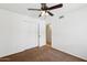 Bedroom featuring a ceiling fan, closet, and light brown carpeted floor at 3228 W Mercer Ln, Phoenix, AZ 85029