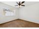 Bright bedroom with a window and ceiling fan, offering a comfortable and airy space at 3228 W Mercer Ln, Phoenix, AZ 85029