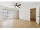 Bright bedroom featuring tile flooring, a ceiling fan, and a walk-in closet at 3228 W Mercer Ln, Phoenix, AZ 85029