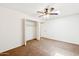 Bedroom with a ceiling fan, closet with open doors, carpeted floors, and bright walls at 3228 W Mercer Ln, Phoenix, AZ 85029