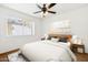 Well-lit bedroom showcasing a comfortable bed, windows, and simple decor at 3228 W Mercer Ln, Phoenix, AZ 85029